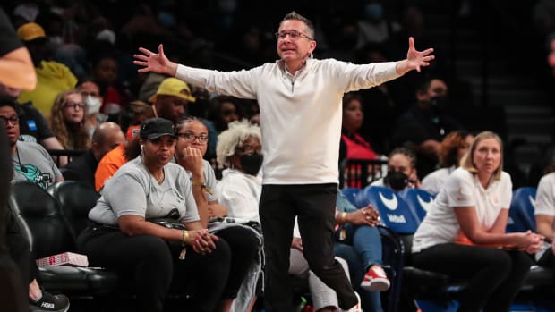 Connecticut Sun coach Curt Miller on the sideline with his arms spread open